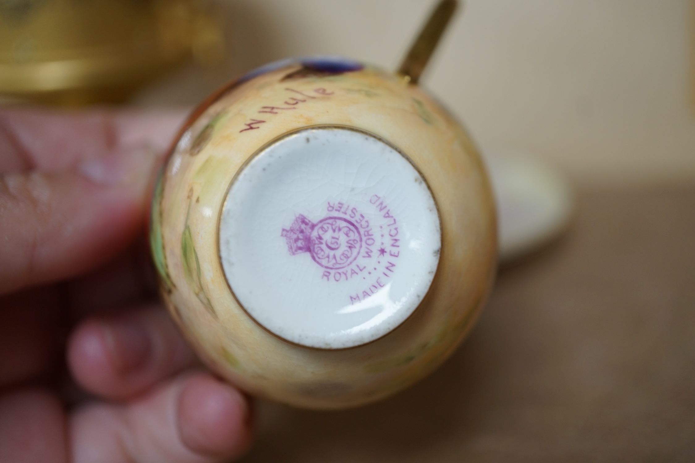 A Royal Worcester miniature fruit painted cup and saucer, Hale and Everett, and an unusual gilded campana vase, 10cm high. Condition - saucer cracked, otherwise good